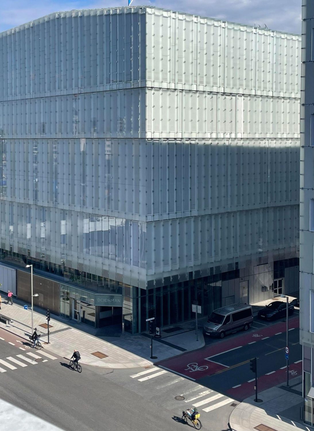 A contemporary shopping center clad in a glass shingle rainscreen facade