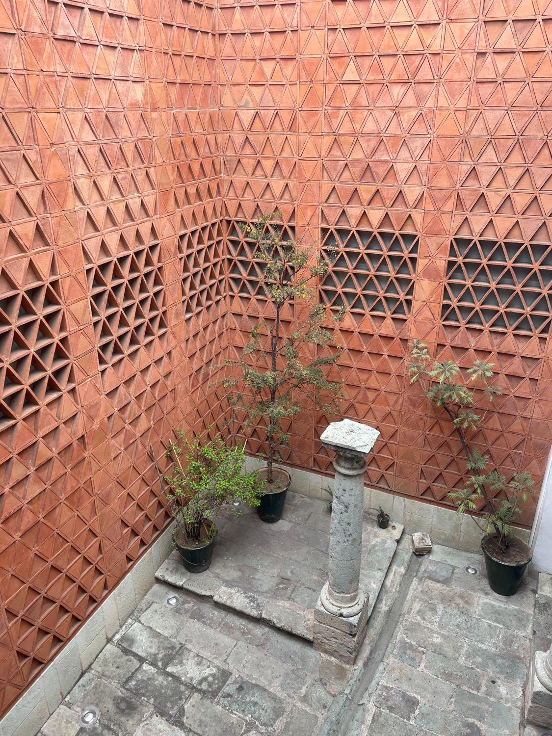 Handmade red-brick double-skin courtyard wall at Museo Textil de Oaxaca